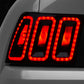 Raxiom 99-04 Ford Mustang Excluding 99-01 Cobra Icon LED Tail Lights- Black Housing (Smoked Lens) - Racecraft Industries